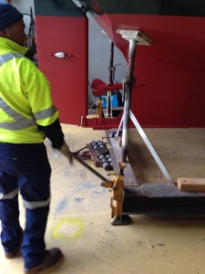 Placing the skates under the boat.
